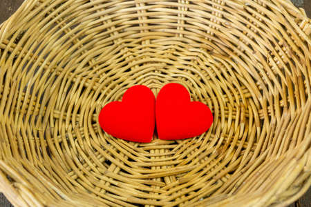 Two red heart on wicker basket, Valentine's Day concept.の写真素材
