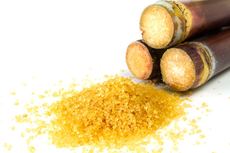Close-up sugar and pile sugarcane isolated on white background.
