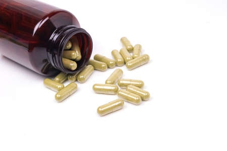 Capsules of Moringa and brown bottle isolated on white background. Moringa oleifera is tropical herb.の写真素材