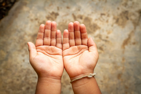 Boy open empty hands with palms up and light. Human hands of praying.の写真素材
