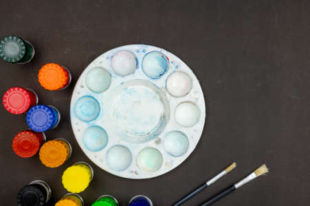 Top view close-up poster color set, Color mixing palette and two paintbrush on black background.の写真素材