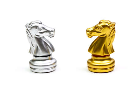 Knight horse chess pieces gold and silver isolated on white background.の写真素材