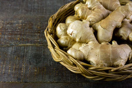 Fresh ginger in basket on rustic wooden background. Ginger is a food and herb for healthcare.の写真素材