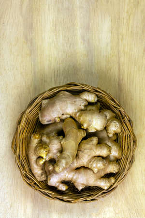 Fresh ginger in basket on rustic wooden background. Ginger is a food and herb for healthcare.の写真素材