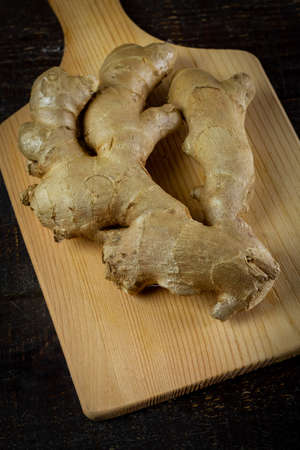 Fresh ginger on rustic wooden background. Ginger is a food and herb for healthcare.の写真素材
