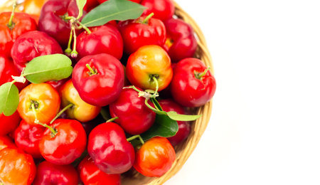 Acerola Cherry or Barbados Cherry on basket isolated on white background.の写真素材