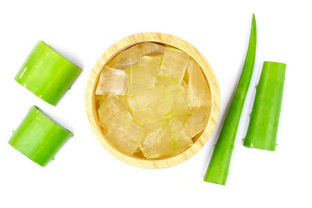 Aloe vera gel in wooden bowl with fresh aloe vera isolated on white background, top view.の写真素材