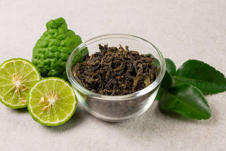 Bergamot tea or Earl Grey tea in transparent glass bowl and fresh bergamot fruit on white background.の写真素材