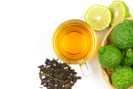Bergamot tea in transparent cup with fresh bergamot fruit isolated on white background, top view, copy space.の写真素材