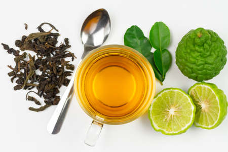 Bergamot tea in transparent cup with fresh bergamot fruit isolated on white background, top view.の写真素材