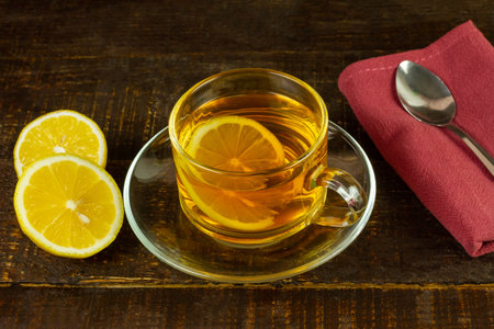 Cup of hot tea and lemon on rustic wooden table.の写真素材