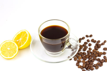 Black coffee in transparent glass with fresh lemon and coffee bean isolated on white background. Espresso romano drink for healthy.の写真素材