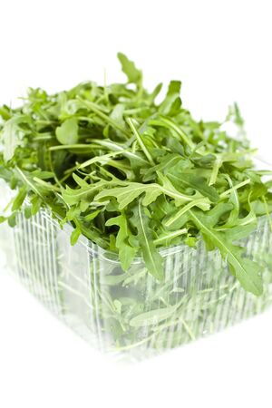 Rucola Leaves In A Plastic Container Isolated On Whiteの写真素材