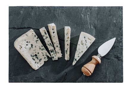 Blue cheese sliced on black board whith knifeの写真素材