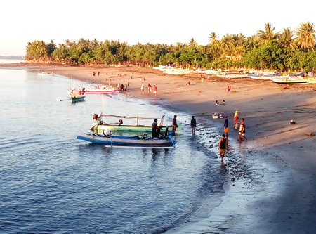 Fishermen on the beach in Goa, India. Traditional fishing boats.の写真素材
