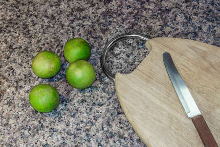 Lemon and cutting board wood with sharp knife to cut on granite stone background. It best for equipment,  food and kitchen.の写真素材