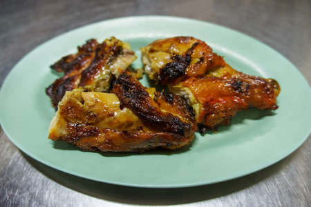 Grilled chicken BBQ (roaster chicken) in dishes on steel table background with copy space. For food.の写真素材
