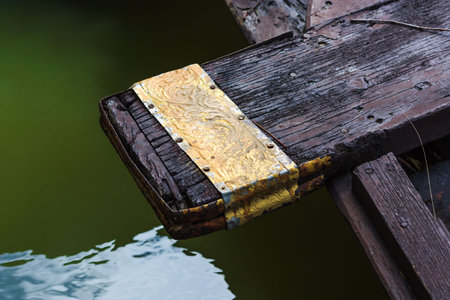 Close-up, element of black Thai wooden boat stay green canal in Ayutthaya, Thailand.