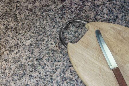 Cutting board wood with sharp knife to cut on granite stone background. It best for equipment,  food and kitchen.の写真素材