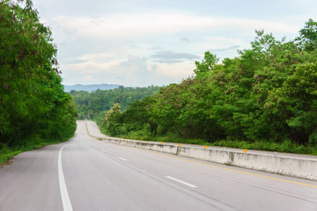 Asphalt road are garden tree and forest in Thailand with green grass with copy space. For background...