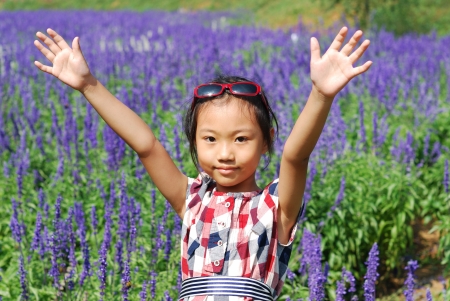 Asian little girl  In summer gardenの写真素材