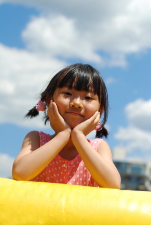 Asian little girl on the blue skyの写真素材