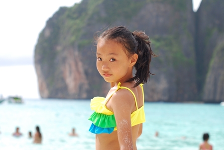 Asian little girl at the beachの写真素材