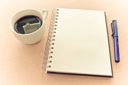 Notebook pen and coffee in sweet motion moment の写真素材