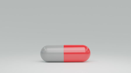 red and white antibiotic medicine pill capsules on table for carの写真素材
