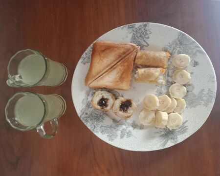 Toast, bananas, lime juice served for breakfastの写真素材