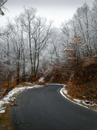A mountain road on a winter day after snowfallの写真素材