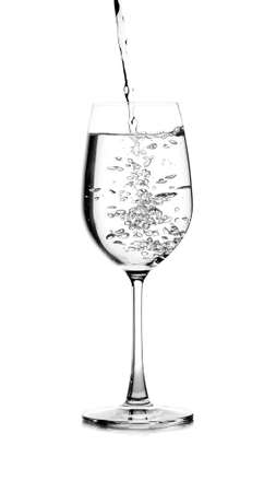 pouring water on a glass on white backgroundの写真素材