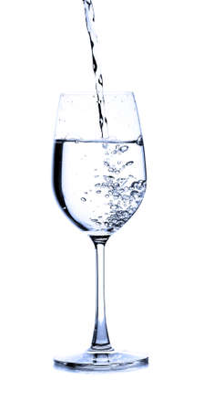 pouring water on a glass on white backgroundの写真素材