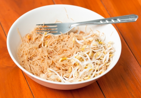 Stir fried mung bean noodle in bowl on the wooden tableの写真素材
