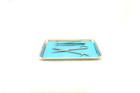 Scissors Biopsy and forceps made from stainless steel, placed on blue pad ,in medical tray.                            の写真素材