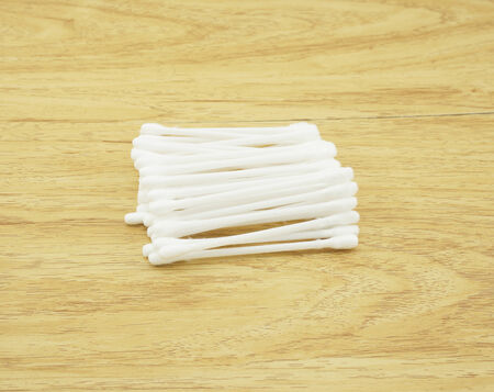 Several of cotton bud, put ogether on the brown wood table                                の写真素材