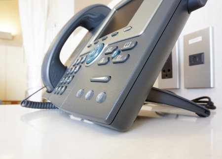 The stylish phone has a gray color, it is one of service in modern hotels.                          ...