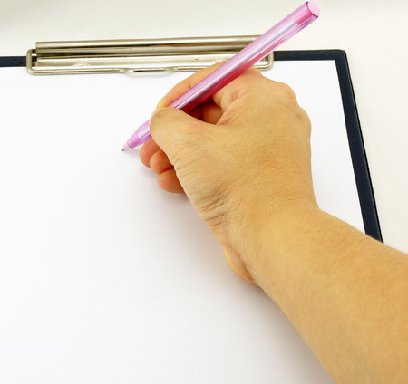 Women are writing notes on a white paper, placed on the board.                               の写真素材