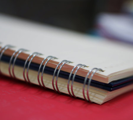 Spiral memory notebook was placed on a table at office.