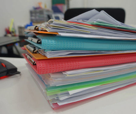 Stack of many color document folder on desk at office.