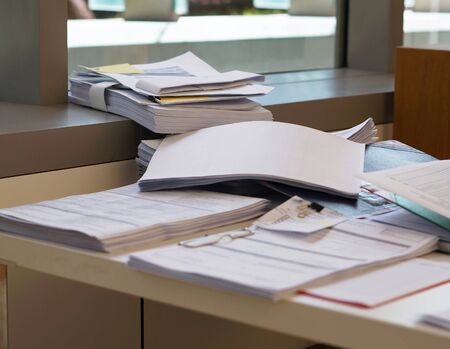 Busy work at office, lot of pile document on desk.の写真素材