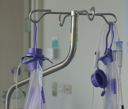 Enteral feeding nutritional supplement to g-tube feeding bag hanging on stand.