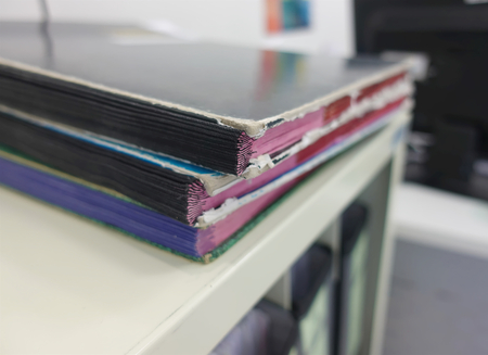 Stack of report paperwork documents for business desk folders, boss report files.の写真素材
