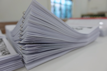 Paper business documents of finished stacked for conference on office desk.の写真素材