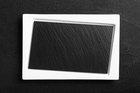 Empty white plate with black stone surface