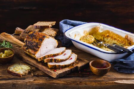 Roasted pork loin on the old wooden tableの写真素材