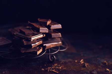 Dark chocolate pieces on dark table