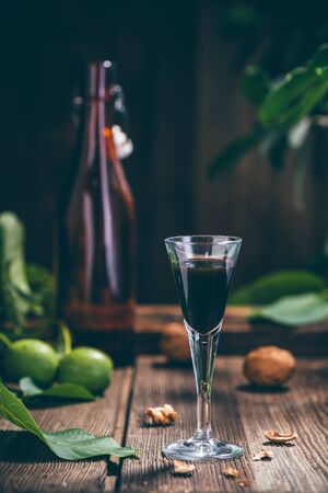 Tincture of walnuts in a glass on the tableの写真素材