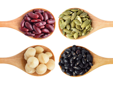 Red beans, black beans, pumpkin seeds and macadamia isolated on whiteの写真素材