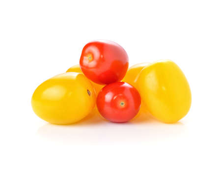 yellow and red tomatoes isolated on whiteの写真素材